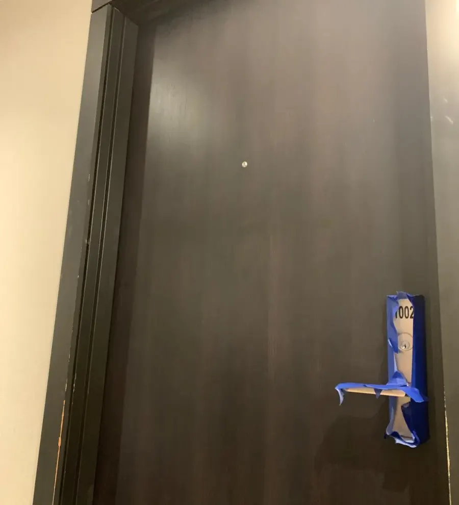 Suite entry door, stain damage refinished after