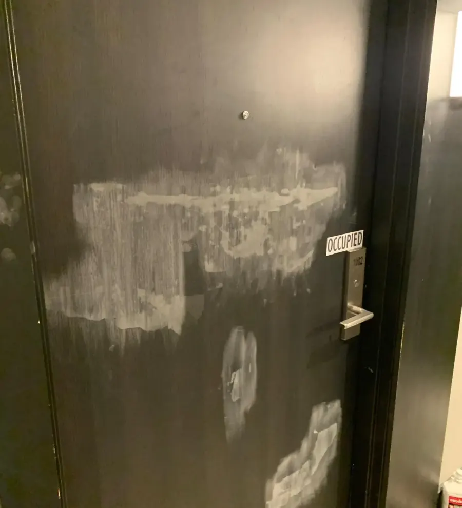 Suite entry door, stain damage refinished before