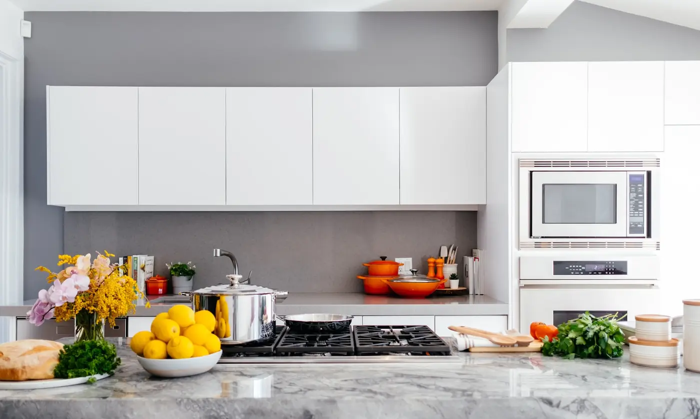 Technician polishing a scratched stainless steel appliance panel