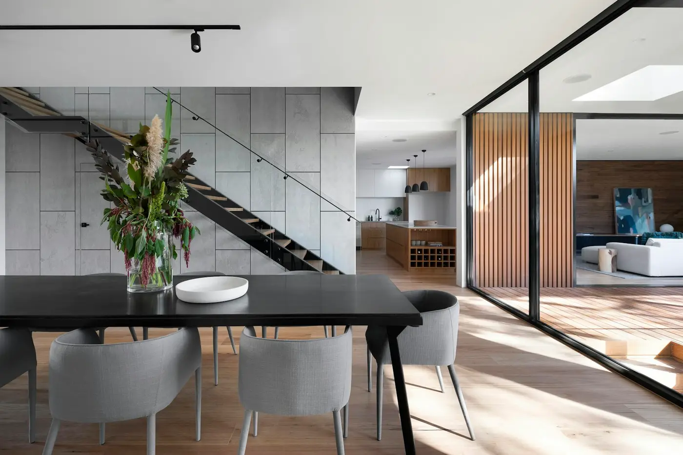 Renovated kitchen with white cabinetry and a quartz island