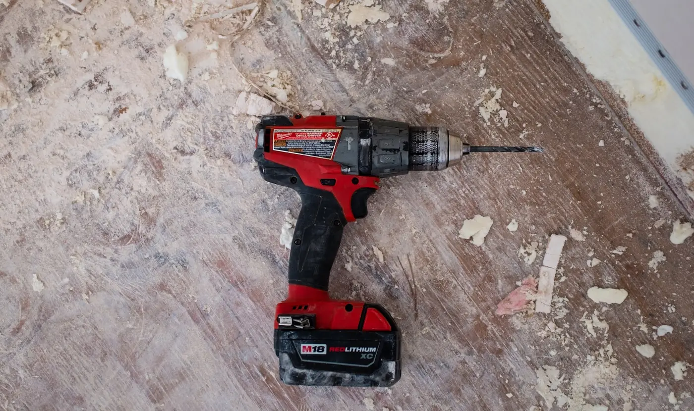 A drill resting on a drywall sanded floor, where Highview started